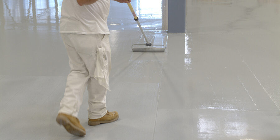 Rollpaint worker scraping the floor